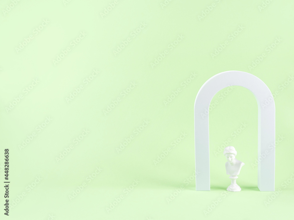 Geometric shape white arch and woman antique statue bust on green background Geometric shape white arch and woman antique statue bust on green background