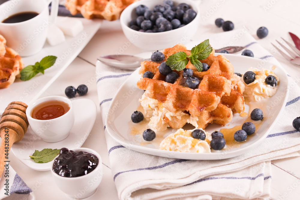 Waffles with blueberries and whipped cream. Waffles with blueberries and whipped cream.