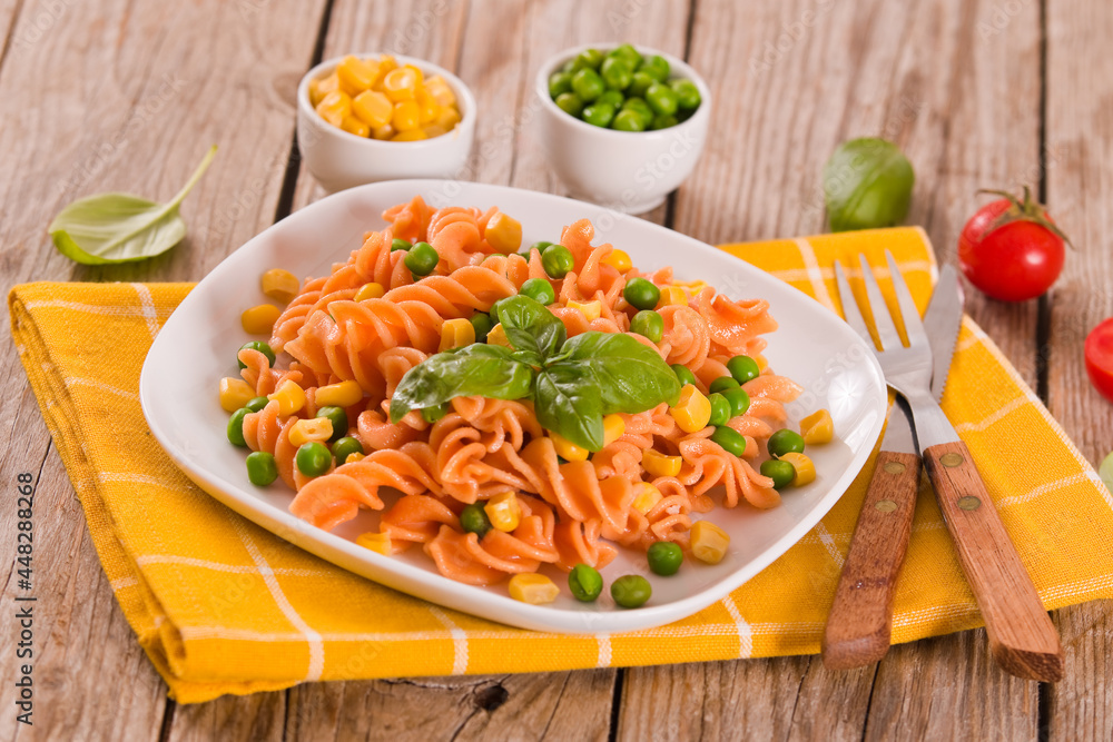 Fusilli pasta with peas and sweet corn.