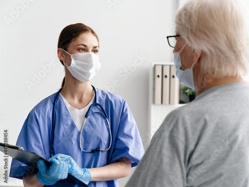 nurse wearing medical mask and elderly woman patient infection immunity covid-19 passport