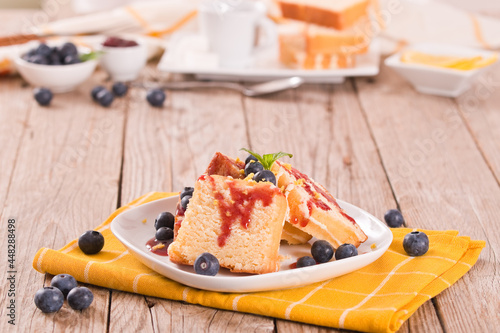 Lemon pund cake with blueberries and strawberry syrup. photo