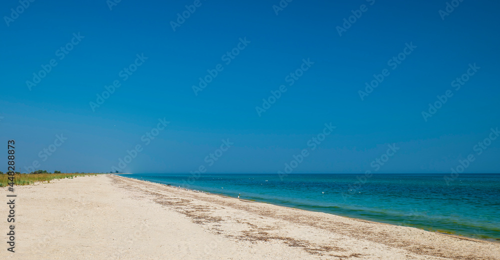 Beautiful seascape. Big beach, lots of sand and water. Summer vacation by the sea. Clear sky blue Beautiful seascape. Big beach, lots of sand and water. Summer vacation by the sea. Clear sky blue