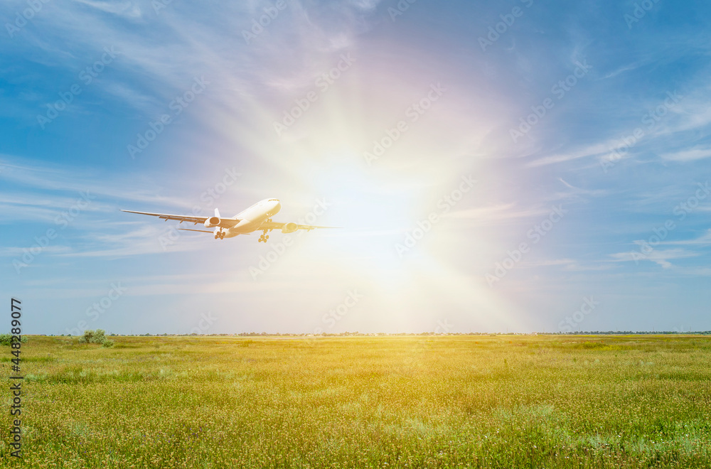 Passenger plane over a green field. Dawn in the morning outdoors. Transport and travel Passenger plane over a green field. Dawn in the morning outdoors. Transport and travel
