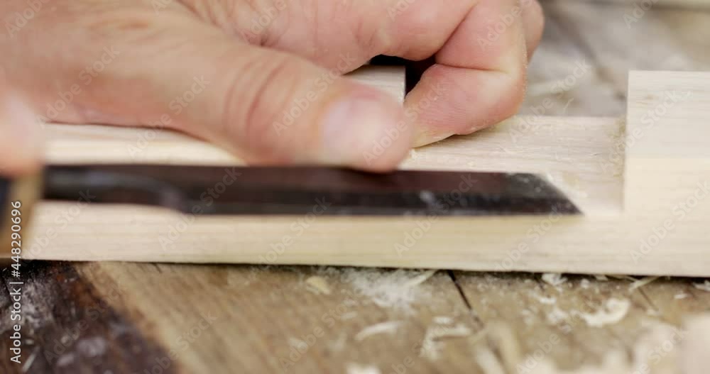 Woodwork joinery, carpenter cutting starting cut on wood slat, close-up Woodwork joinery, carpenter cutting starting cut on wood slat, close-up