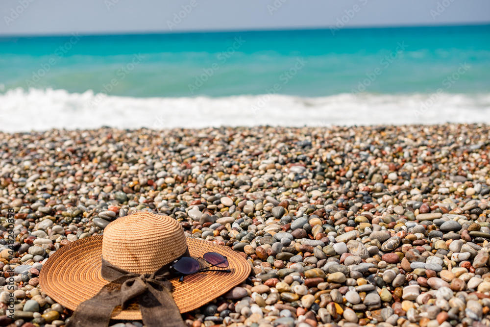 hat and sunglasses on the beach hat and sunglasses on the beach