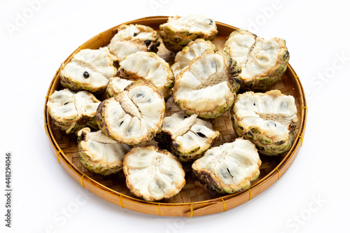 Custard apple in bamboo basket on white background.