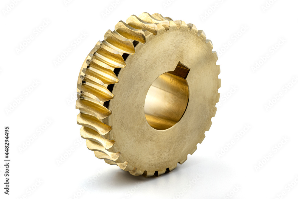 A macro photo of a new shiny copper gear, isolated on a white background. A macro photo of a new shiny copper gear, isolated on a white background.