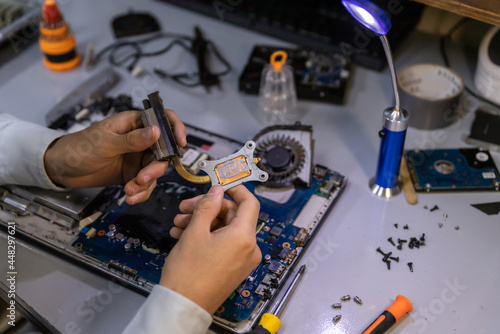 technician removing processor from motherboard