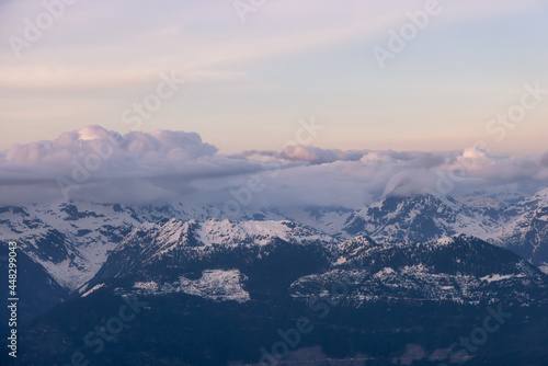 Fototapeta Naklejka Na Ścianę i Meble -  Aerial View from Airplane of Canadian Mountain Landscape in Spring time. Colorful Sunset Sky. North of Vancouver, British Columbia, Canada. Authentic Image