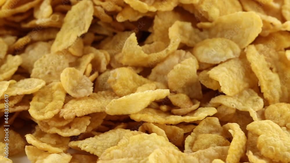 Heap of cornflakes rotating close up, cereal breakfast or food concept Heap of cornflakes rotating close up, cereal breakfast or food concept