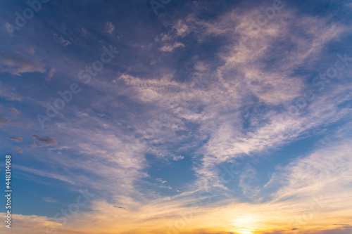 sunset / sun rise sky with rays of yellow and red light shining clouds and sky background and texture