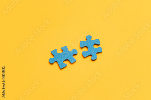 Top View of a Blue Puzzle Peaces Lie on the Yellow Background