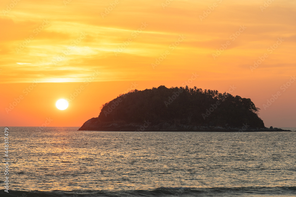 scenery yellow sky the sun going down to the sea..beautiful golden sky at sunset in Kata beach Phuket Thailand.high quality image for travel concept.