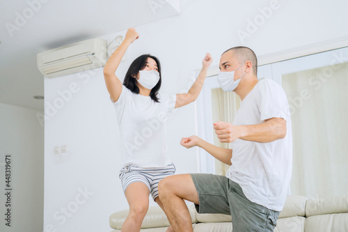 Happy couple doing silly dance during self isolation