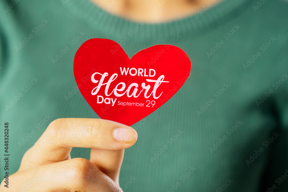 Woman hands showing world heart day text Woman hands showing world heart day text
