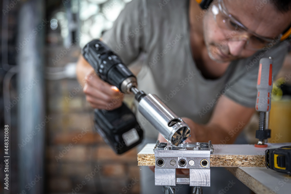 A carpenter works with professional woodworking tools.