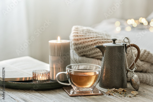Slika na platnu Cozy composition with a cup of tea, a teapot and candles.