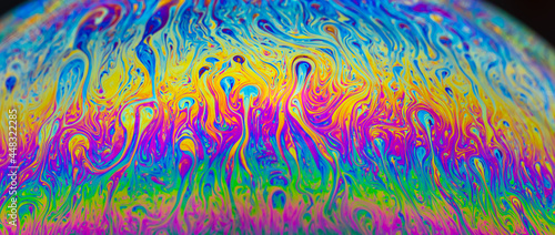 Abstract colourful background with patterns and rainbow effects in soap and bubbles.
