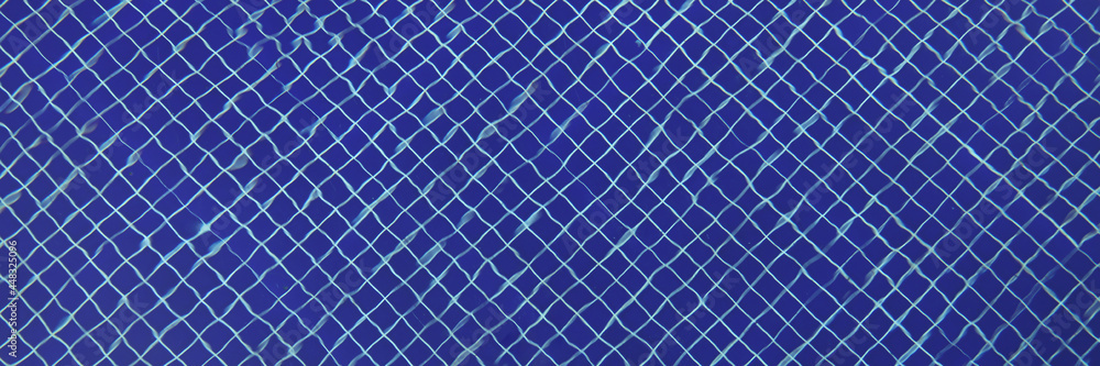 Blue mosaic tiles at bottom of transparent pool Blue mosaic tiles at bottom of transparent pool