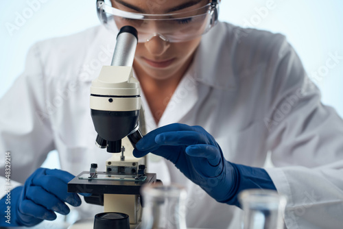 female doctor laboratory microscope study closeup