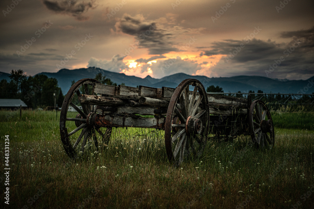 Wagon in the field with sunset - obrazy, fototapety, plakaty 