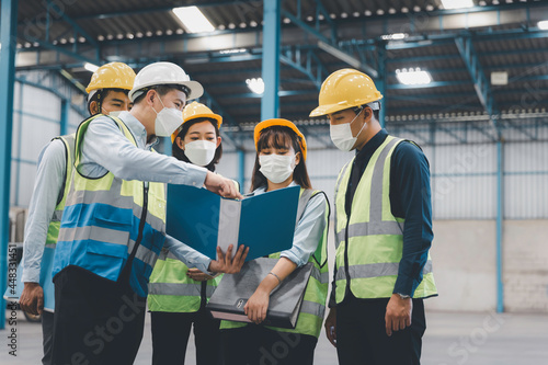 Group of working staff in face medical mask having safety meeting at factory, Working safety and health concept