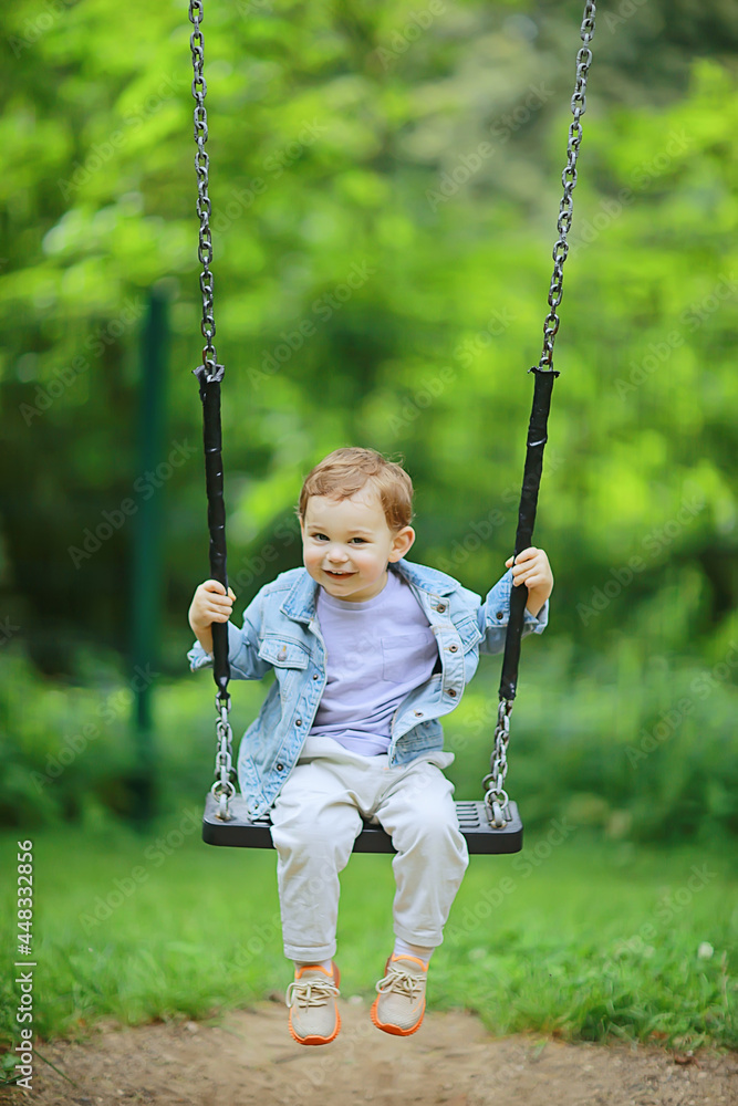 springtime, a boy in the spring swinging on a swing, leisure enjoyment childhood summer happy child springtime, a boy in the spring swinging on a swing, leisure enjoyment childhood summer happy child
