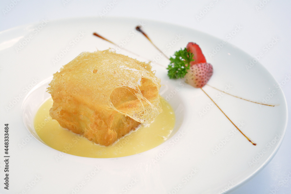 deep fried crispy golden premium durian dessert with yellow sauce in white background asian halal menu