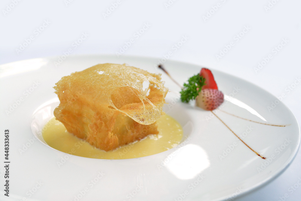 deep fried crispy golden premium durian dessert with yellow sauce in white background asian halal menu