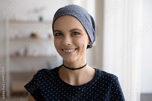 Принти на полотні Head shot portrait of smiling sincere millennial caucasian woman wearing scarf on bald head struggling with oncology disease, feeling optimistic about cancer fight, remission or recovery concept