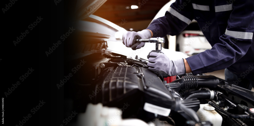 Auto mechanic working on car engine in mechanics garage.Repair service,car service, repair, maintenance concept. Auto mechanic working on car engine in mechanics garage.Repair service,car service, repair, maintenance concept.