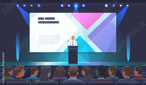 A male speaker speaks behind the podium with a speech at a presentation in a large conference room full of spectators. A politician or businessman, a teacher giving a speech at an international forum.
