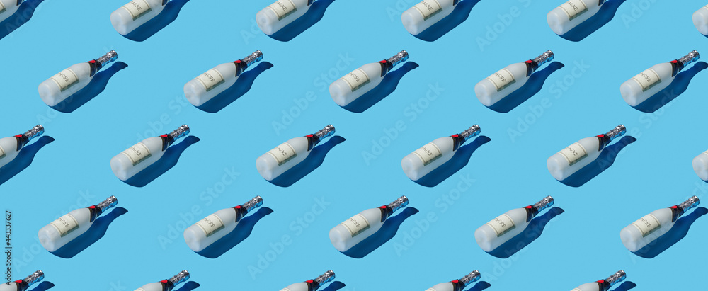 Pattern of champagne bottles on blue pastel background Pattern of champagne bottles on blue pastel background