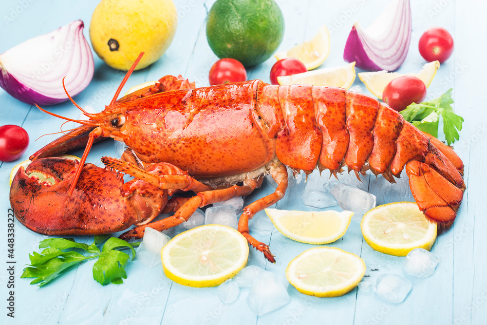 Seafood feast,Lemon and fresh Boston lobster on the ice Seafood feast,Lemon and fresh Boston lobster on the ice