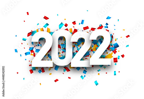 Fotografia 2022 white sign over colourful confetti.