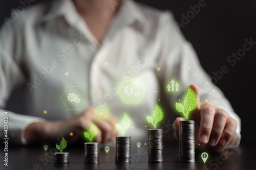 Concepts of economic technology future business Eco friendly new trading platform. Businessman with coin stack and hologram chart.