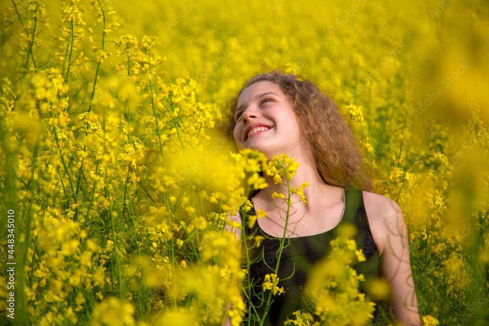 Blonde girl with luxurious long hair in a blooming rapeseed field of Ukraine Blonde girl with luxurious long hair in a blooming rapeseed field of Ukraine