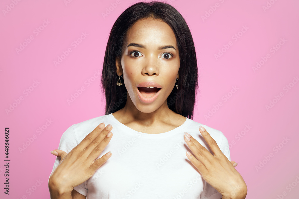 pretty woman african appearance long hairstyle white t-shirt pink background pretty woman african appearance long hairstyle white t-shirt pink background