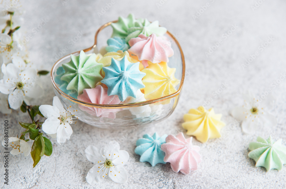 Small colorful meringues in the  heart shaped bowl