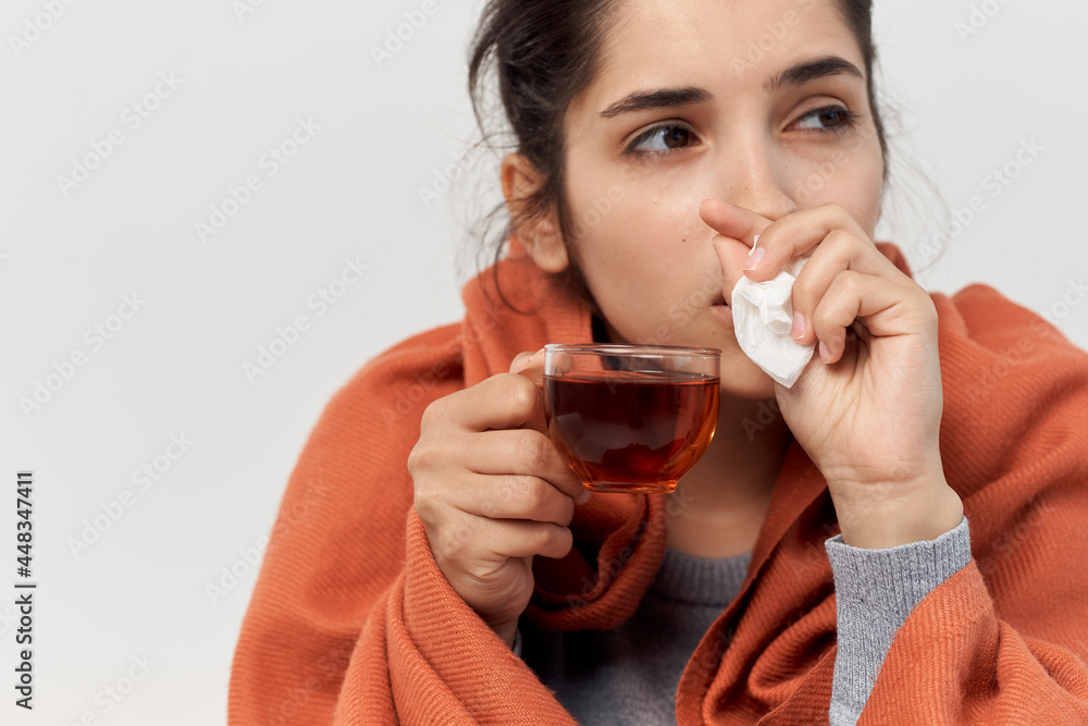 woman covering herself with a blanket at home cold infection woman covering herself with a blanket at home cold infection