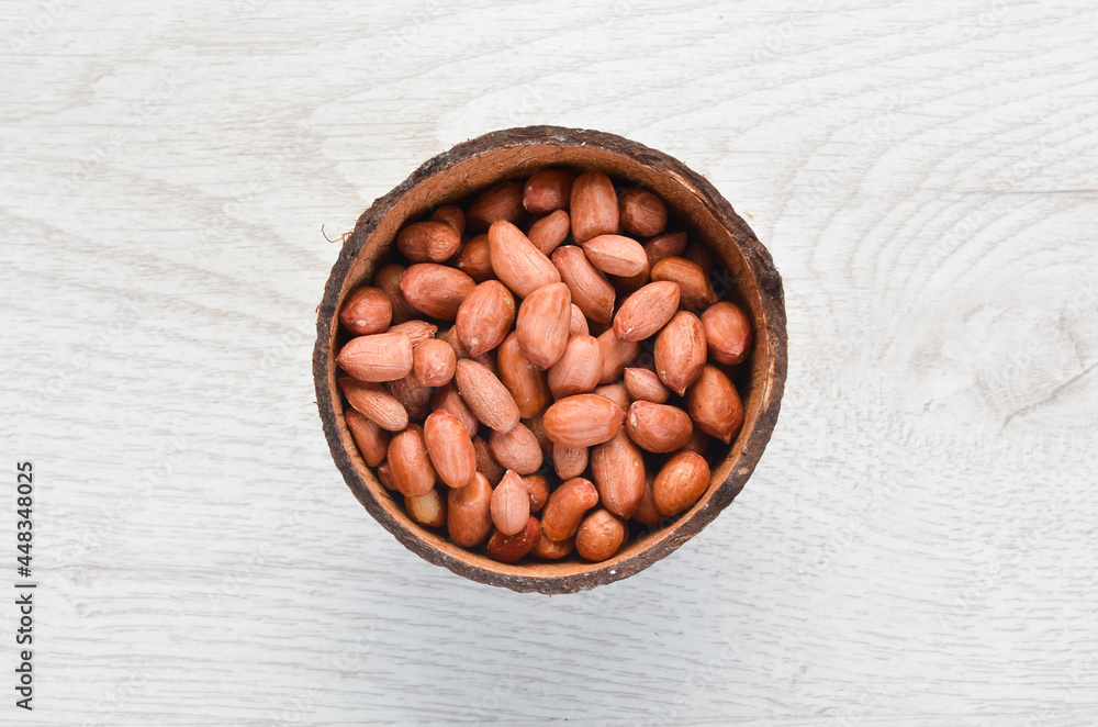 Peanuts in bowl on old table. Nut background. Top view. Peanuts in bowl on old table. Nut background. Top view.