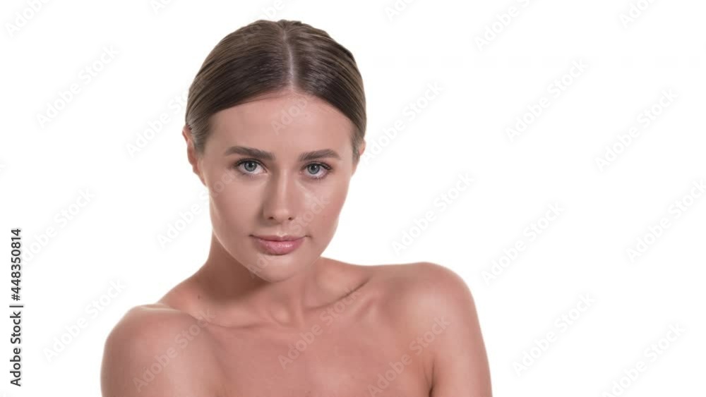 Portrait of a beautiful Caucasian woman, turning from back to chest, looking at the camera, smiling. White background. Beauty concept. Portrait of a beautiful Caucasian woman, turning from back to chest, looking at the camera, smiling. White background. Beauty concept.
