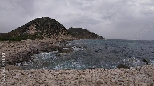 Bad weather on the coasts with strong wind and waves crashing on the rocks in timelapse