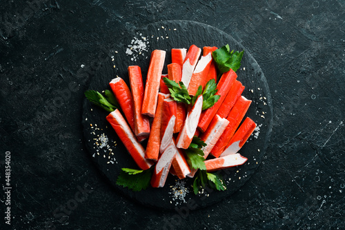 Photography Crab sticks from a crab on a black stone plate