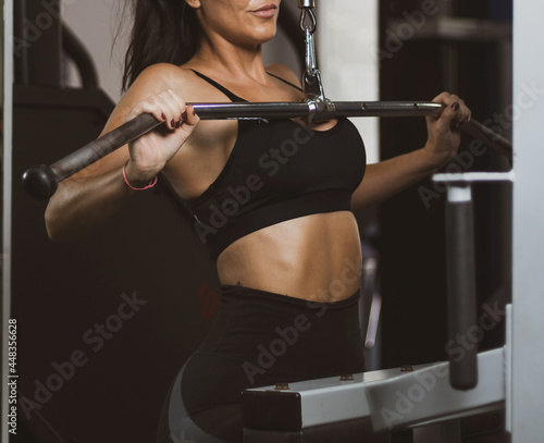 a girl working her back in a gym