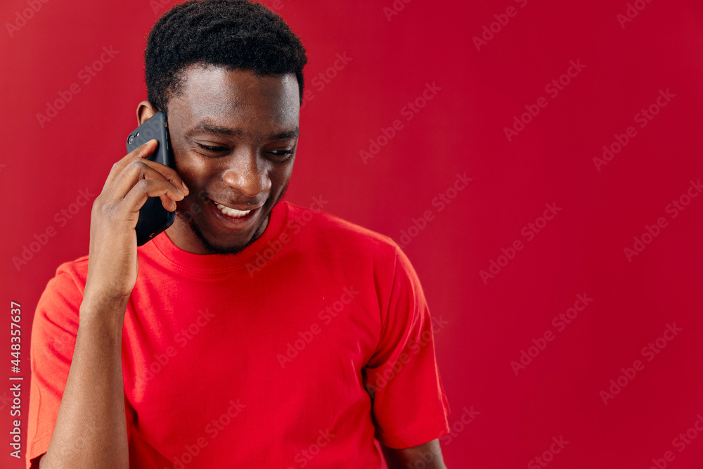 Cheerful man of african appearance talking on the phone technology Cheerful man of african appearance talking on the phone technology