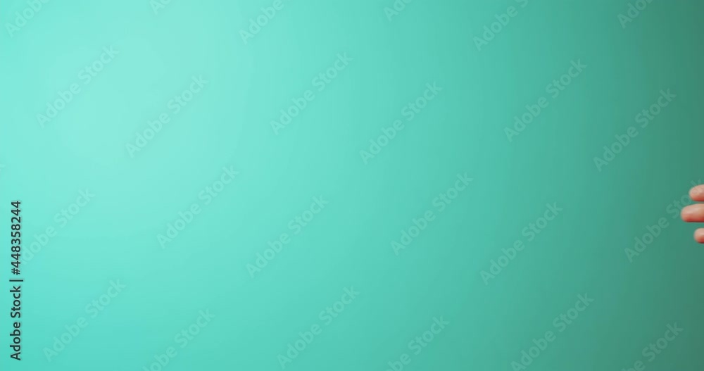 Close up female hand showing template mockup Bank credit card with online service isolated on green background Close up female hand showing template mockup Bank credit card with online service isolated on green background