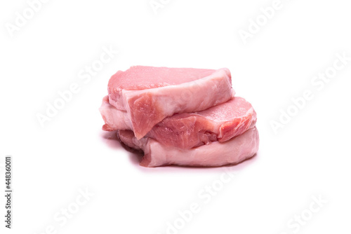 Raw pork pieces isolated on a white background.