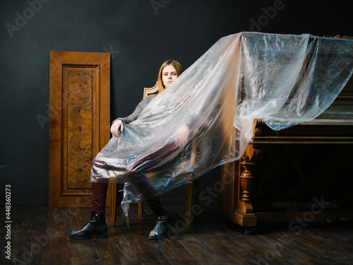 woman sitting on a chair near the piano interior romance