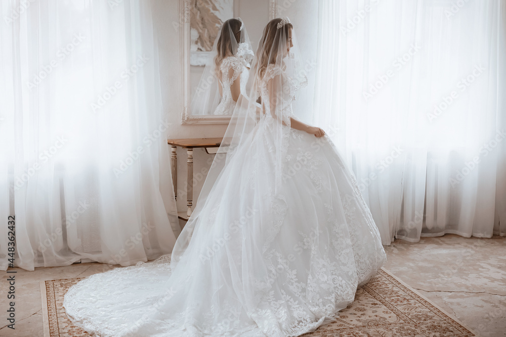 Beautiful young bride with light make-up in white dress in an exquisite interior Beautiful young bride with light make-up in white dress in an exquisite interior